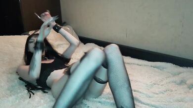 Goth pixie in fishnet stockings having fun with magic whip