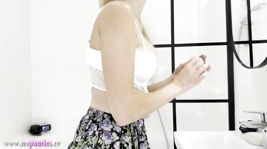 Blonde bombshell in tennis skirt shows off huge tits no panties in bathroom solo