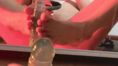 Crystal silicone cock wedged into sheer high-cut swimsuit while she moans on her little toy