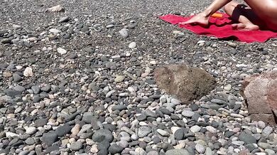 Oiled exhibitionist gets caught nude on public beach