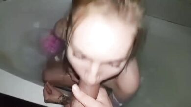 Blonde takes golden shower while dripping on huge tits