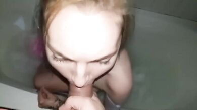 Blonde takes golden shower while dripping on huge tits