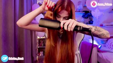 Redhead tease strips naked curling her hair on stream