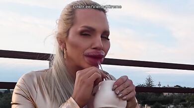 Bimbo with giant lips tries to drink without making a mess no glass works