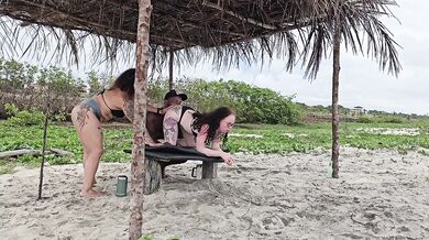 Milf rides two tight butts on beach drenching them with cum