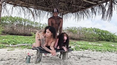 Milf rides two tight butts on beach drenching them with cum