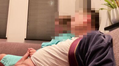 Wife gives casual handjob on couch while watching TV side view milf