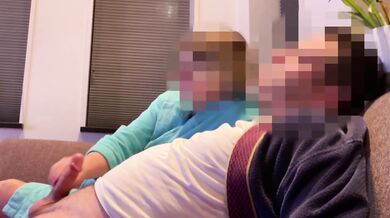 Wife gives casual handjob on couch while watching TV side view milf