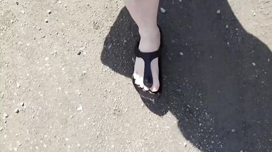 Black caftan and barefoot Birkenstocks in the wild
