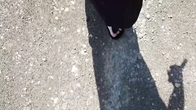 Black caftan and barefoot Birkenstocks in the wild