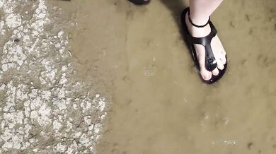 Black caftan and barefoot Birkenstocks in the wild