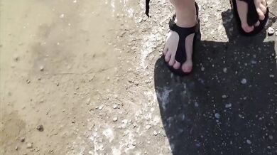 Black caftan and barefoot Birkenstocks in the wild