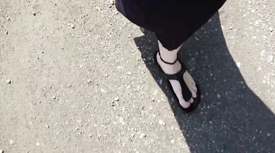 Black caftan and barefoot Birkenstocks in the wild