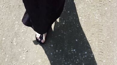 Black caftan and barefoot Birkenstocks in the wild