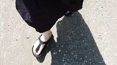 Black caftan and barefoot Birkenstocks in the wild