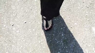 Black caftan and barefoot Birkenstocks in the wild