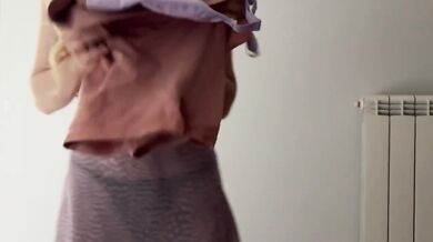 Skinny blonde teases while trying on tight gym outfits for you to choose