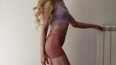 Skinny blonde teases while trying on tight gym outfits for you to choose