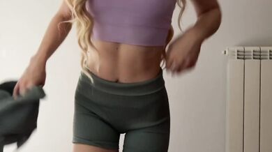 Skinny blonde teases while trying on tight gym outfits for you to choose