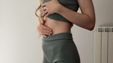 Skinny blonde teases while trying on tight gym outfits for you to choose