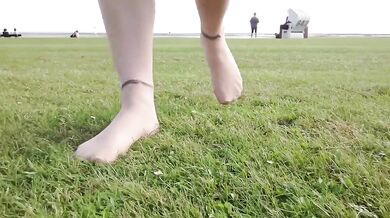 Feet in fine stockings splashing the Wadden Sea Wangerland