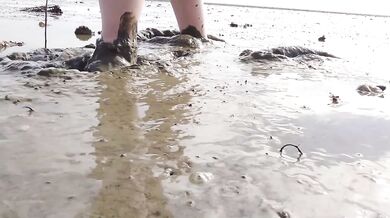 Feet in fine stockings splashing the Wadden Sea Wangerland