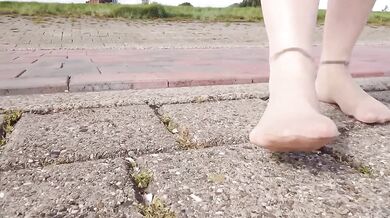 Feet in fine stockings splashing the Wadden Sea Wangerland