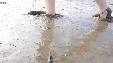 Feet in fine stockings splashing the Wadden Sea Wangerland