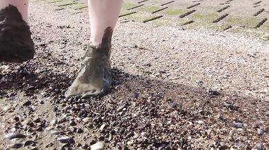 Feet in fine stockings splashing the Wadden Sea Wangerland