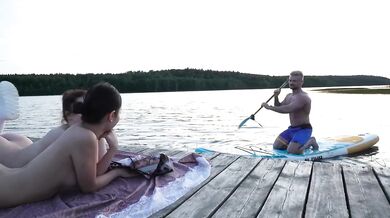 Two Girls Took Their Clothes Off On The Lake And A Passing Surfer Had Sex In The Open Air
