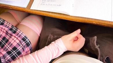 Japanese schoolgirl handjob under table in public classroom cumshot