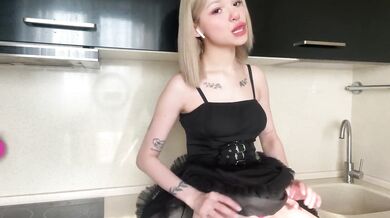 Blonde in sexy dress plays with her pussy