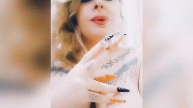 Curvy girl smokes a cigarette