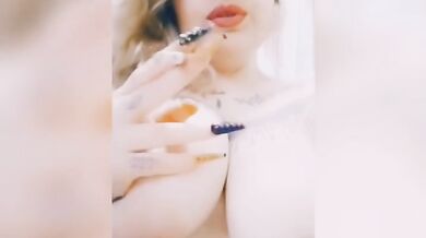 Curvy girl smokes a cigarette