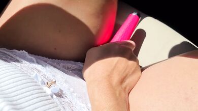 Sexy blonde girl masturbates with a vibrator while driving