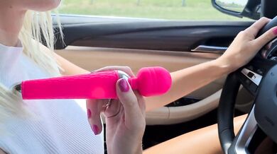 Sexy blonde girl masturbates with a vibrator while driving