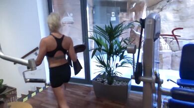 Blonde masturbates in the bathroom in the gym