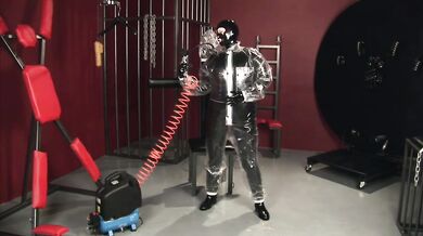 Blonde girl in black latex catsuit full encased in inflatable rubber and full body plastic suit