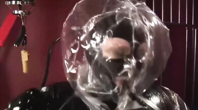 Blonde girl in black latex catsuit full encased in inflatable rubber and full body plastic suit