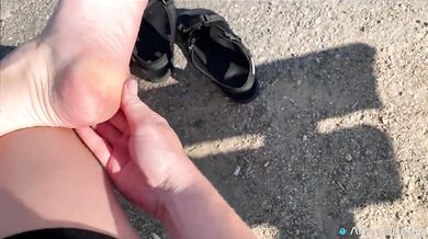 A Girl Walks In Nature In A Skirt And Massages Her Feet