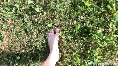 A Girl Walks In Nature In A Skirt And Massages Her Feet
