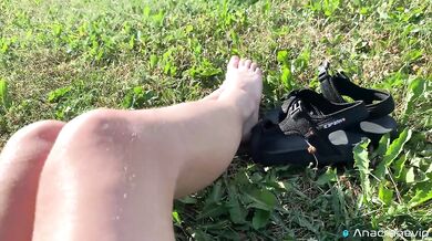 A Girl Walks In Nature In A Skirt And Massages Her Feet