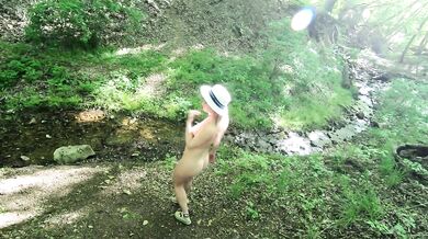 Nudist girl walks in the woods