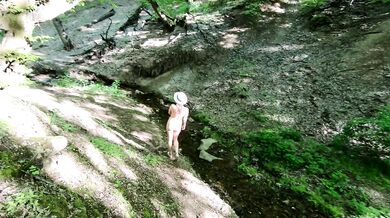 Nudist girl walks in the woods