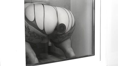 Fucking with a huge dildo. View through the balcony door.