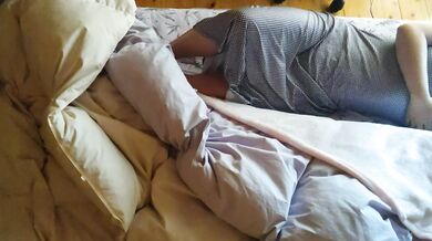 [Voyeur style] of an amateur woman hugging a blanket on the bed and masturbating