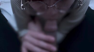 A girl with neat glasses gets ejaculated in the mouth.