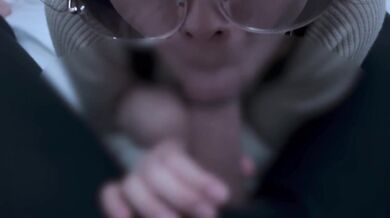 A girl with neat glasses gets ejaculated in the mouth.
