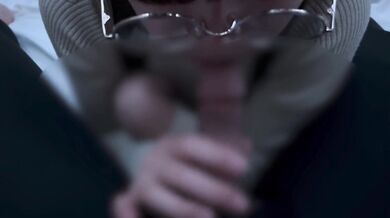 A girl with neat glasses gets ejaculated in the mouth.