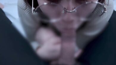 A girl with neat glasses gets ejaculated in the mouth.